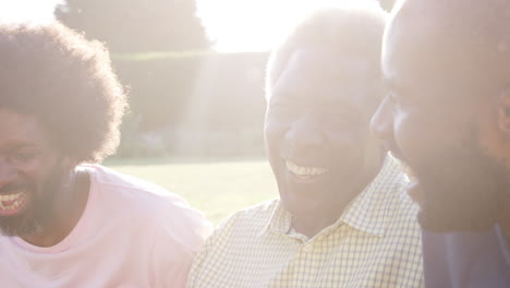 Senior-black-man-laughing-with-his-two-adult-sons,-close-up
