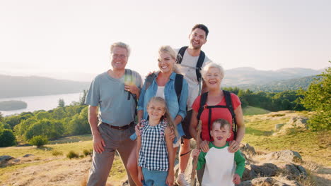 Slow-Motion-Portrait-Of-Multi-Generation-Family-Standing-At-Top-Of-Hill-On-Hike-Through-Countryside-In-Lake-District-UK