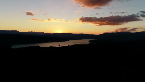 Aerial-view-of-sunset-over-Lake-Windermere,-Lake-District,-UK