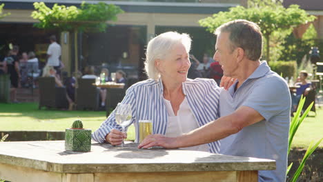 Senior-Couple-Enjoying-Outdoor-Summer-Drink-At-Pub