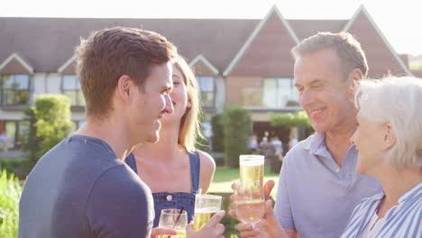 Parents-With-Adult-Offspring-Enjoying-Outdoor-Summer-Drink-At-Pub