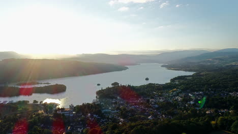 Aerial-view-of-the-village-on-the-lakeshore-and-surrounding-countryside-at-Lake-Windermere,-Lake-District,-UK