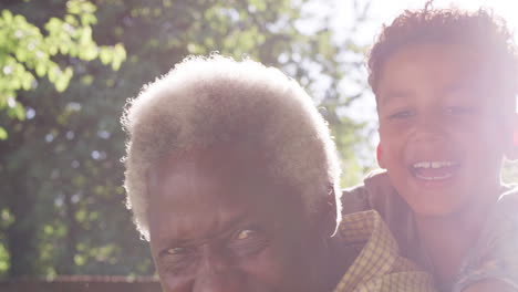 Senior-black-man-with-grandson-riding-on-his-back,-close-up