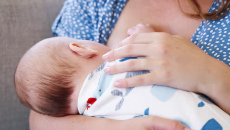 Slow-Motion-Close-Up-Shot-Of-Mother-Sitting-On-Sofa-At-Home-And-Breastfeeding-Baby