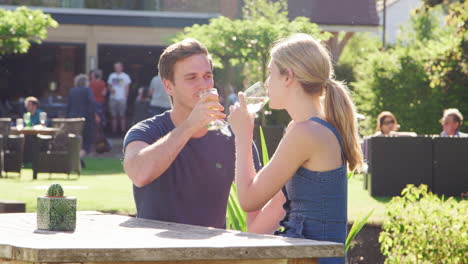 Couple-Enjoying-Outdoor-Summer-Drink-At-Pub