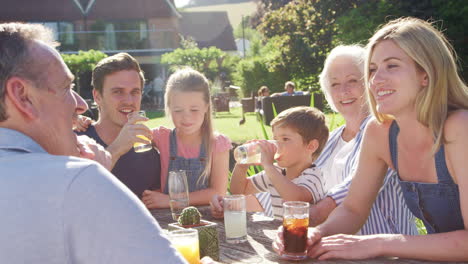 Multi-Generation-Family-Enjoying-Outdoor-Summer-Drink-At-Pub