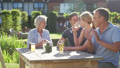 Multi-Generation-Family-Enjoying-Outdoor-Summer-Drink-At-Pub