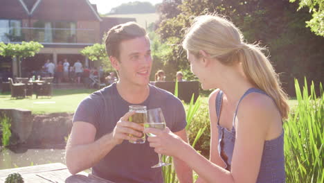 Couple-Enjoying-Outdoor-Summer-Drink-At-Pub