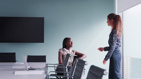 Two-Casually-Dressed-Businesswomen-Having-Informal-Meeting-In-Modern-Boardroom-Shot-In-Slow-Motion