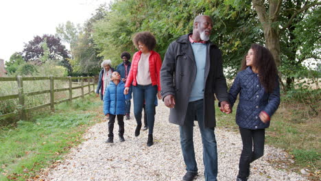 Multi-Generation-Family-On-Autumn-Walk-In-Countryside-Together