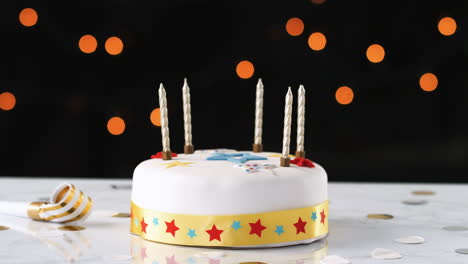 Jump-cut,-stop-frame-animation,-of-seven-candles-appearing-and-disappearing-from-a-birthday-cake,-a-party-blower-beside-it,-bokeh-lights-in-the-background
