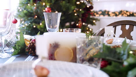Tilt-shot-of-a-bauble-name-card-holder-arrenged-on-a-Christmas-dinner-table,-close-up
