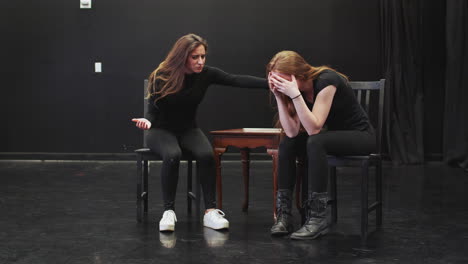 Two-Female-Drama-Students-At-Performing-Arts-School-In-Studio-Improvisation-Class-Acting-Out-Scene