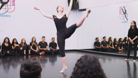 Female-Ballet-Student-At-Performing-Arts-School-Performs-For-Class-And-Teacher-In-Dance-Studio
