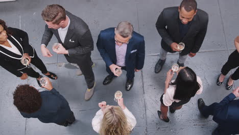 Overhead-Shot-Of-Business-Team-Socializing-With-Drinks-At-After-Work-Meeting-In-Modern-Office