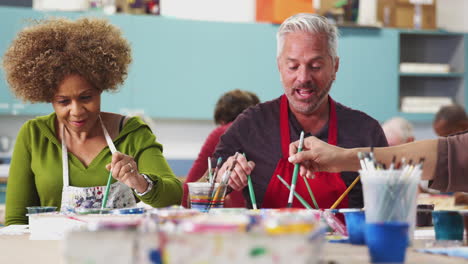 Pull-Focus-Shot-Of-Mature-Students-Attending-Art-Class-In-Community-Centre