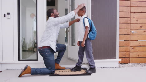 Father-Giving-Son-High-Five-As-She-Leaves-For-School