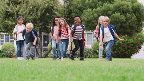 Portrait-Of-Excited-Elementary-School-Pupils-On-Playing-Field-At-Break-Time