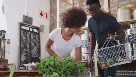 Junges-Paar-Kauft-Frisches-Obst-Und-Gemüse-In-Einem-Nachhaltigen,-Plastikfreien-Lebensmittelladen