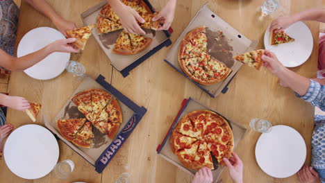 Draufsicht-Einer-Familie-Aus-Mehreren-Generationen,-Die-Am-Tisch-Sitzt-Und-Gemeinsam-Pizza-Isst