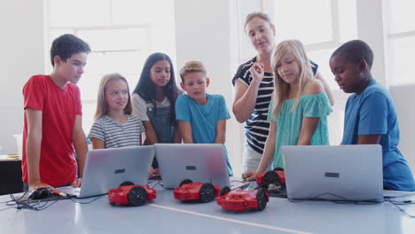 Excited-Students-Watching-Robot-Vehicle-Move-After-Coding-Lesson-In-Computer-Programing-Class