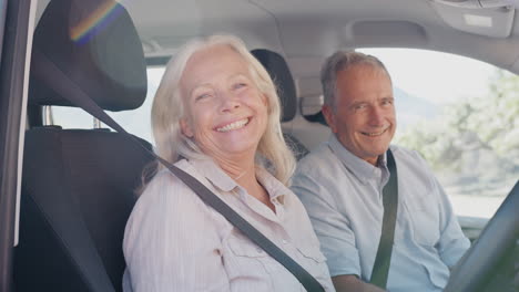 Portrait-Of-Senior-Couple-Sitting-In-And-Driving-Hire-Car-On-Summer-Vacation