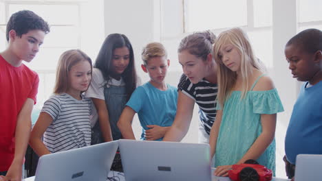 Students-With-Female-Teacher-In-After-School-Computer-Coding-Class-Learning-To-Program-Robot-Vehicle