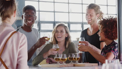 Waitress-Serving-Group-Of-Friends-At-Beer-Tasting-In-Bar
