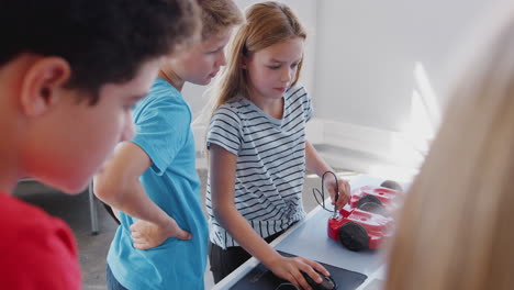 Group-Of-Students-In-After-School-Computer-Coding-Class-Learning-To-Program-Robot-Vehicle