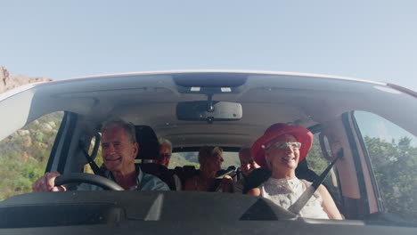 View-From-Outside-Vehicle-As-Group-Of-Senior-Friends-Drive-Car-To-Vacation-Destination