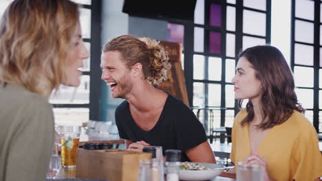 Group-Of-Young-Friends-Meeting-For-Drinks-And-Food-In-Restaurant
