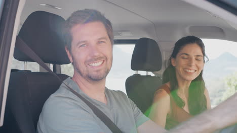Portrait-Of-Mid-Adult-Couple-Sitting-In-And-Driving-Hire-Car-On-Summer-Vacation