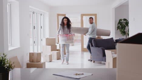 Loving-Couple-Surrounded-By-Boxes-Hug-As-They-Move-Into-New-Home-Together