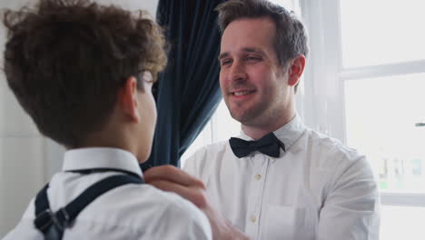 Father-And-Son-Wearing-Matching-Outfits-Getting-Ready-For-Wedding-At-Home