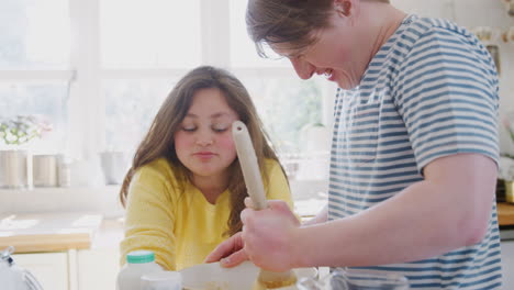 Young-Downs-Syndrome-Couple-Mixing-Ingredients-For-Cake-Recipe-They-Are-Baking-In-Kitchen-At-Home