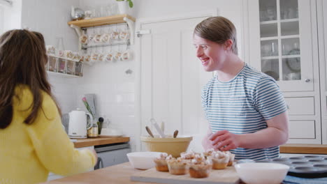 Young-Downs-Syndrome-Couple-Decorating-Homemade-Cupcakes-And-Dancing-In-Kitchen-At-Home