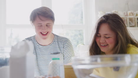 Young-Downs-Syndrome-Couple-Having-Fun-Baking-In-Kitchen-At-Home