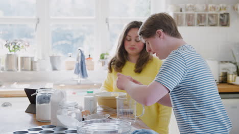 Young-Downs-Syndrome-Couple-Cracking-Eggs-For-Cake-Recipe-They-Are-Baking-In-Kitchen-At-Home