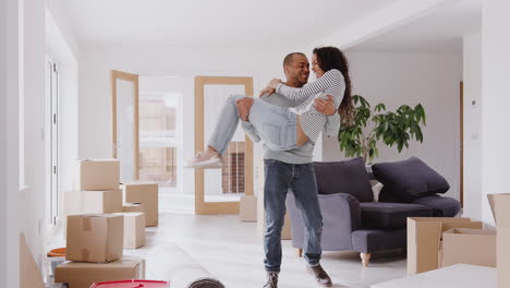 Man-Carrying-Woman-Over-Threshold-Of-New-Home-On-Moving-Day