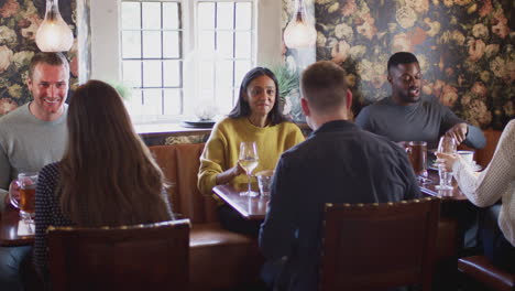 Group-Of-People-Eating-In-Restaurant-Of-Busy-Traditional-English-Pub