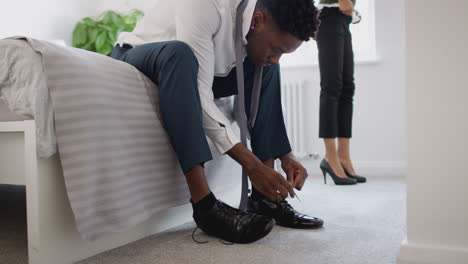 Business-Couple-In-Bedroom-Getting-Ready-For-Work-Businesswoman-At-Home-Putting-On-Shoes