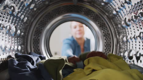 View-Looking-Out-From-Inside-Washing-Machine-As-Woman-Takes-Out-Laundry