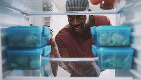 View-Looking-Out-From-Inside-Of-Refrigerator-As-Man-Takes-Out-Healthy-Packed-Lunch-In-Container