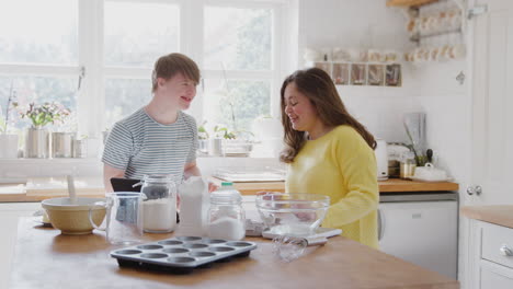Young-Downs-Syndrome-Couple-Having-Fun-Baking-In-Kitchen-At-Home