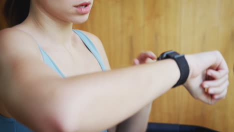 Woman-Exercising-On-Treadmill-At-Home-Checking-Smart-Watch