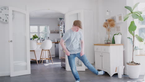 Young-Downs-Syndrome-Man-Having-Fun-Dancing-At-Home