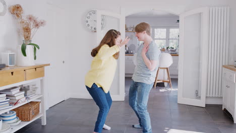 Young-Downs-Syndrome-Couple-Having-Fun-Dancing-At-Home-Together