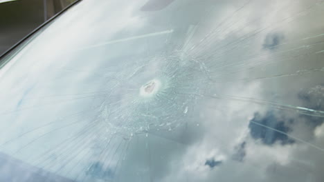 Detail-Of-Damage-To-Windscreen-Of-Car-Shattered-By-Vandalism