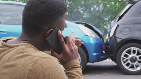 Male-Driver-Involved-In-Car-Accident-Calling-Insurance-Company-From-Roadside