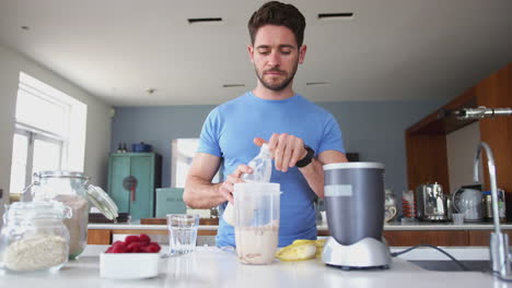 Man-Making-Protein-Shake-After-Exercise-At-Home